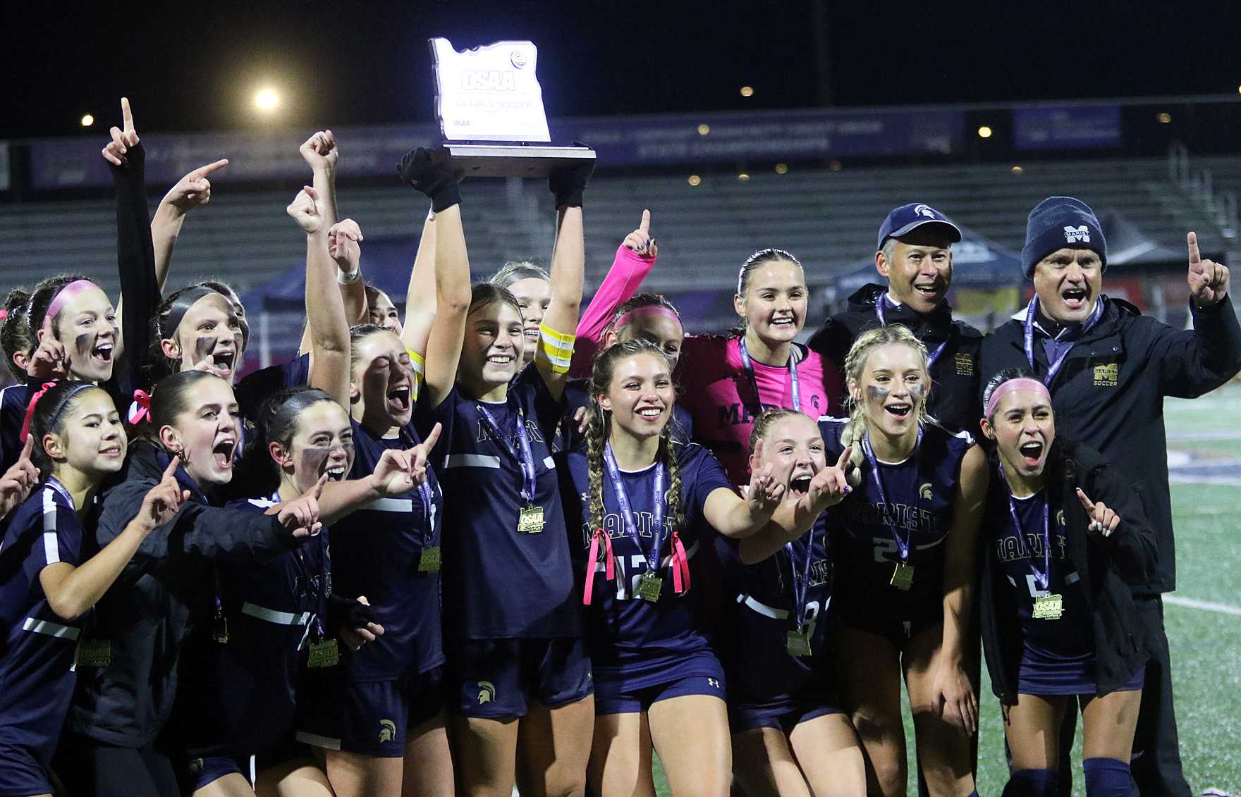 The Marist Catholic girls soccer team celebrates following its 5-0 state championship win over La Grande. (Photo by Dan Brood).