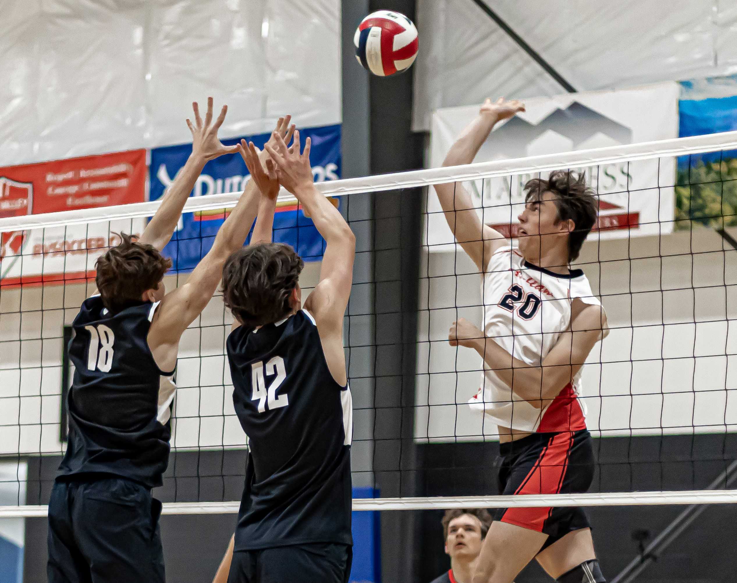 Ashland's Sebastian Hunter (20) hits against North Medford's Calvin McGary (42) and Kolton Preston. (Crystal Clear Photography)