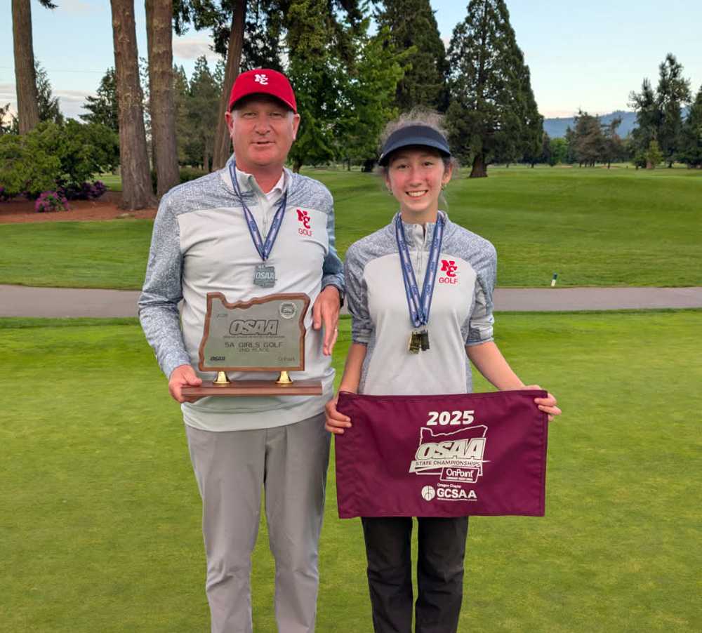 Francie Tomp and coach Shawn Brandt share a moment of triumph following the North Eugene senior's fourth straight state title