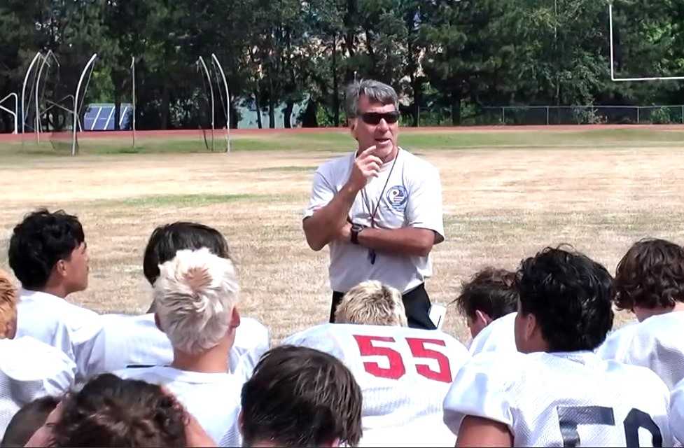 Phoenix coach Charlie Hall addresses his South Valley Wolfpack team during a practice this week. (Photo by Joe Zavala)