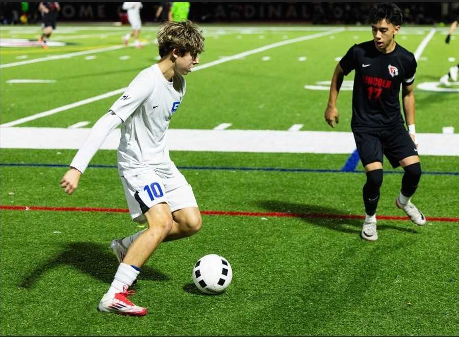 Grant's Ewan Massimino (10) works against the defense of Lincoln's Jack Muirhead (17) on Oct. 14. (Ben Teese/Portland Preps)