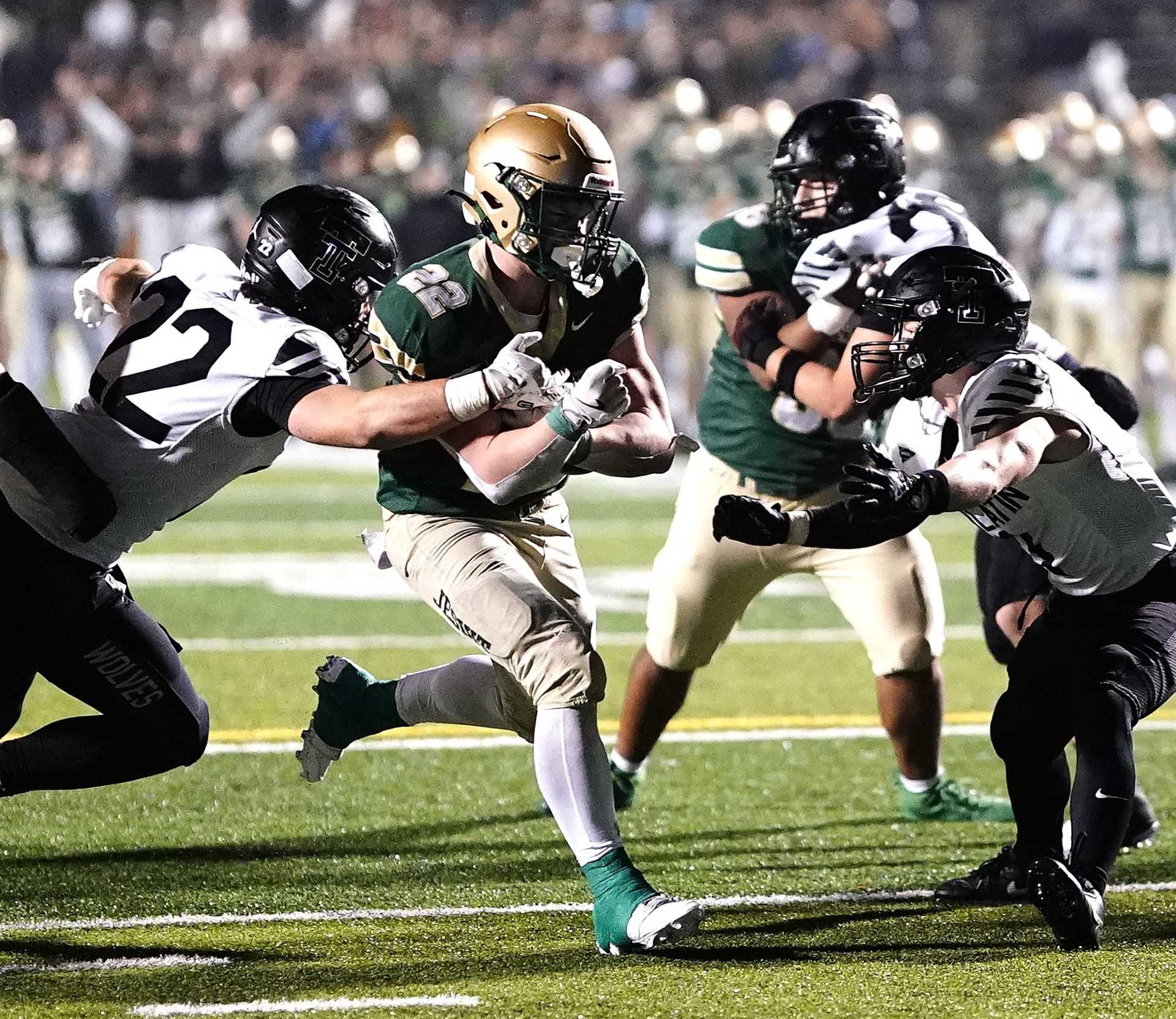 Jesuit's Luke Ortner runs for one of his four touchdowns in Friday's overtime win over visiting Tualatin. (Photo by J.R. Olson)