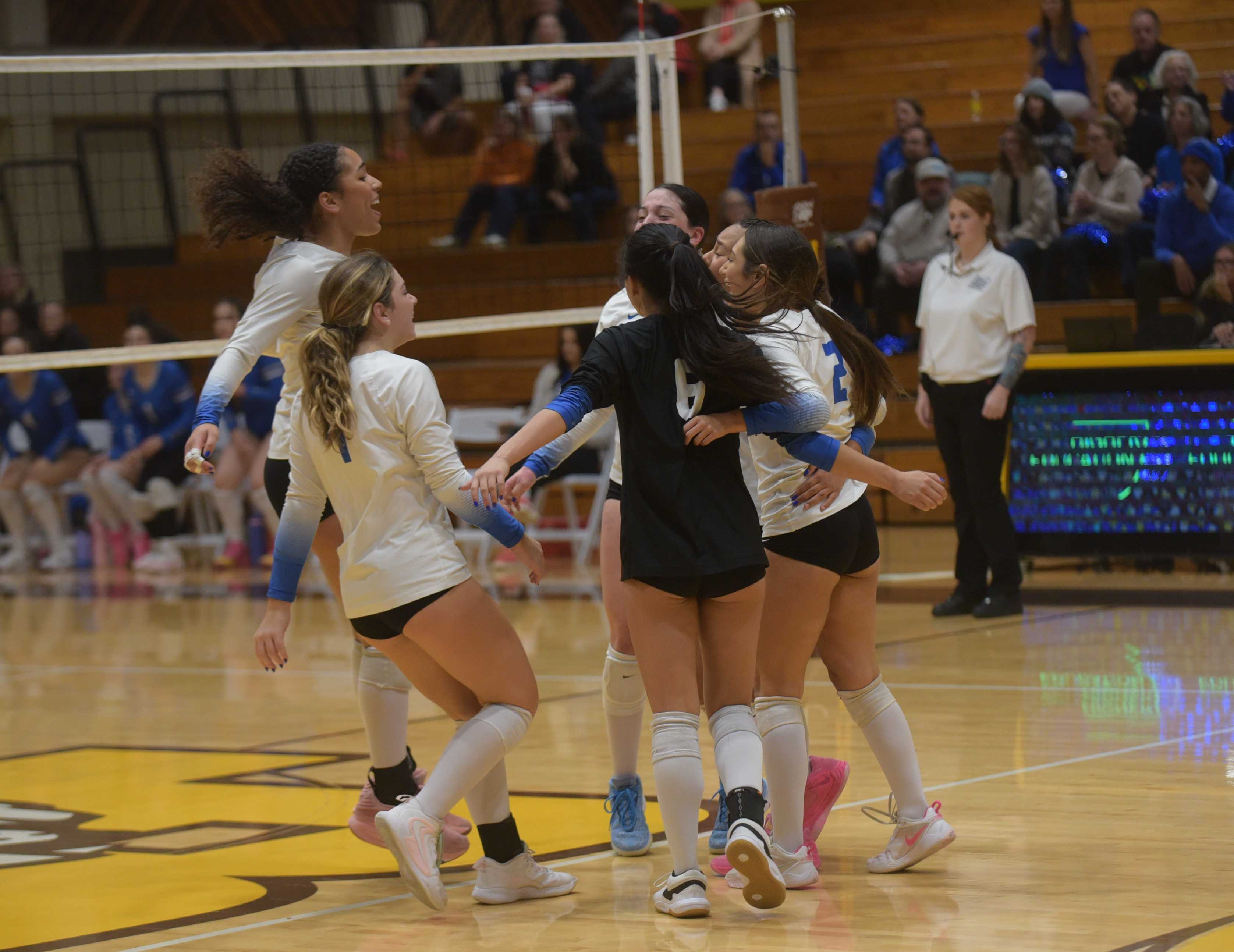 Valley Catholic's players celebrate their first-set win against Catlin Gabel on Friday (John Gunther photo)