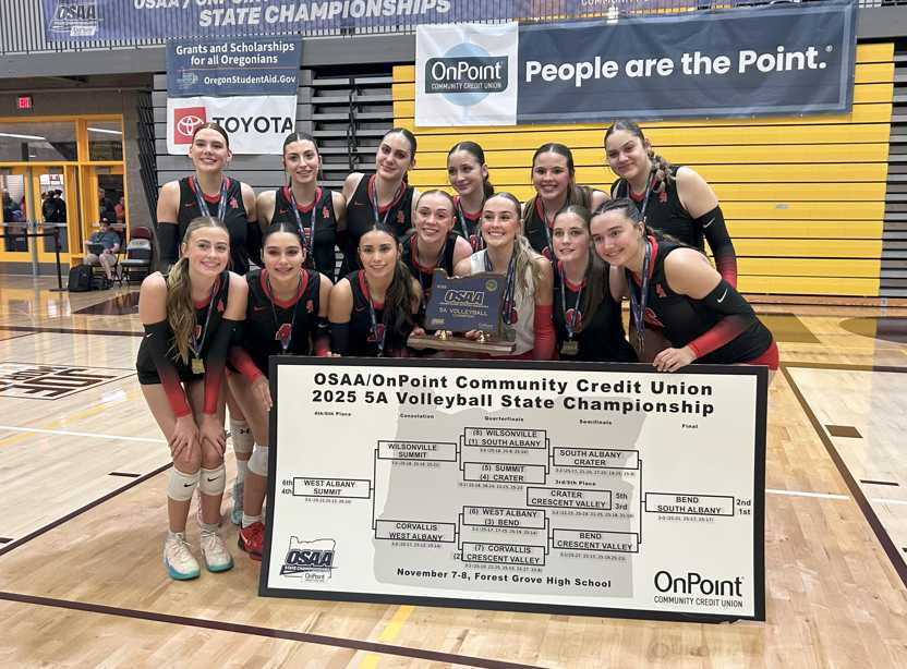 The South Albany volleyball celebrates its state championship victory. (Photo by Chris Burkhardt)