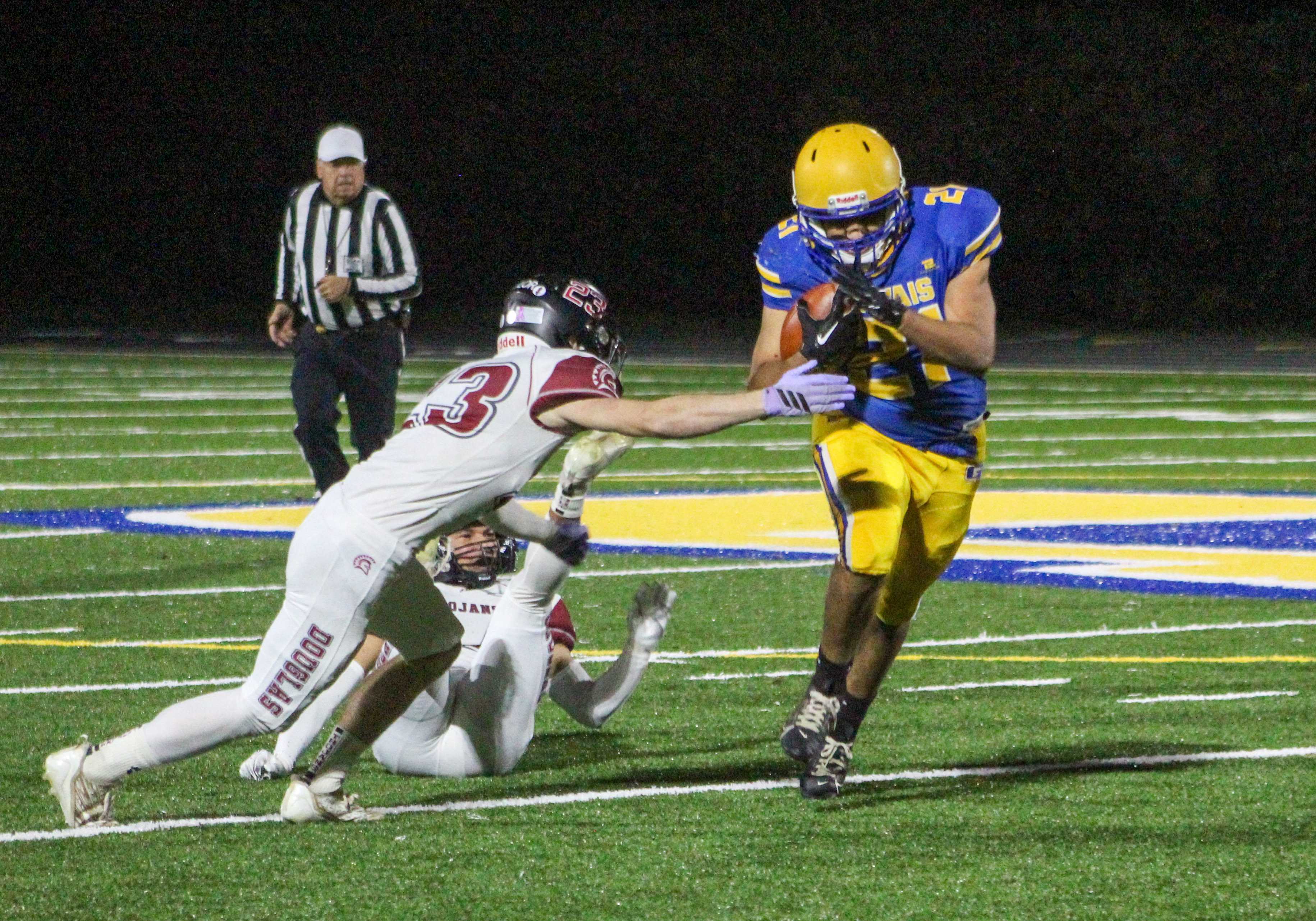 Gervais senior Johnny Mariano, right, runs the ball against Douglas in the 3A quarterfinals. (Photo by Austin White)