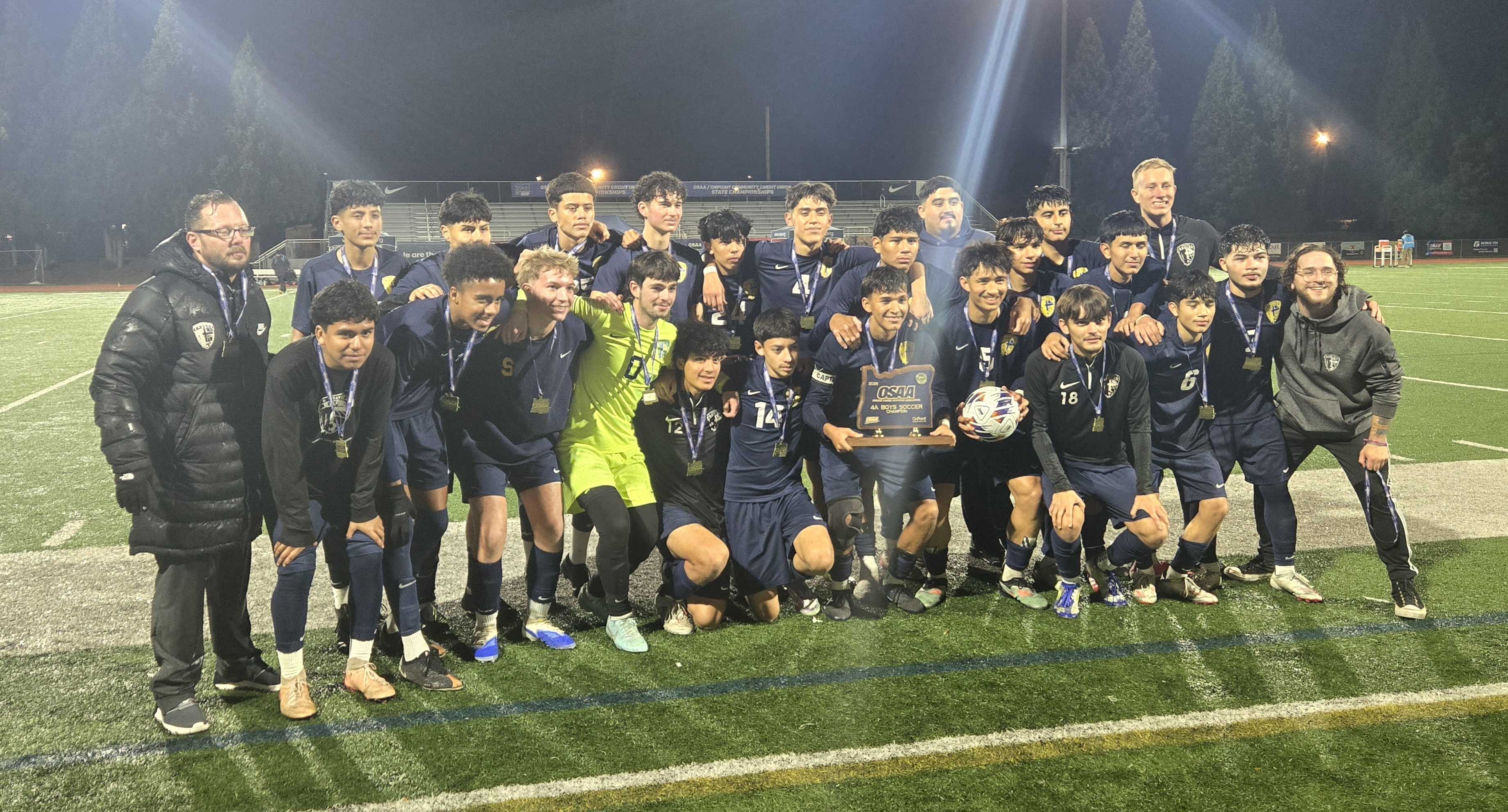 The Stayton boys soccer team celebrates with the trophy after winning the 4A state title. (Photo by Austin White)
