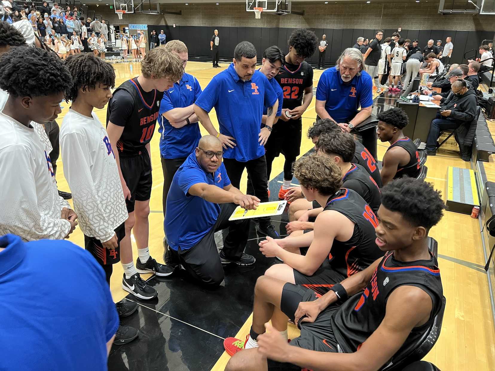 Benson coach Earl Clark outlines options during the fourth quarter of Friday's season opener at Mountainside (Jim Beseda photo)