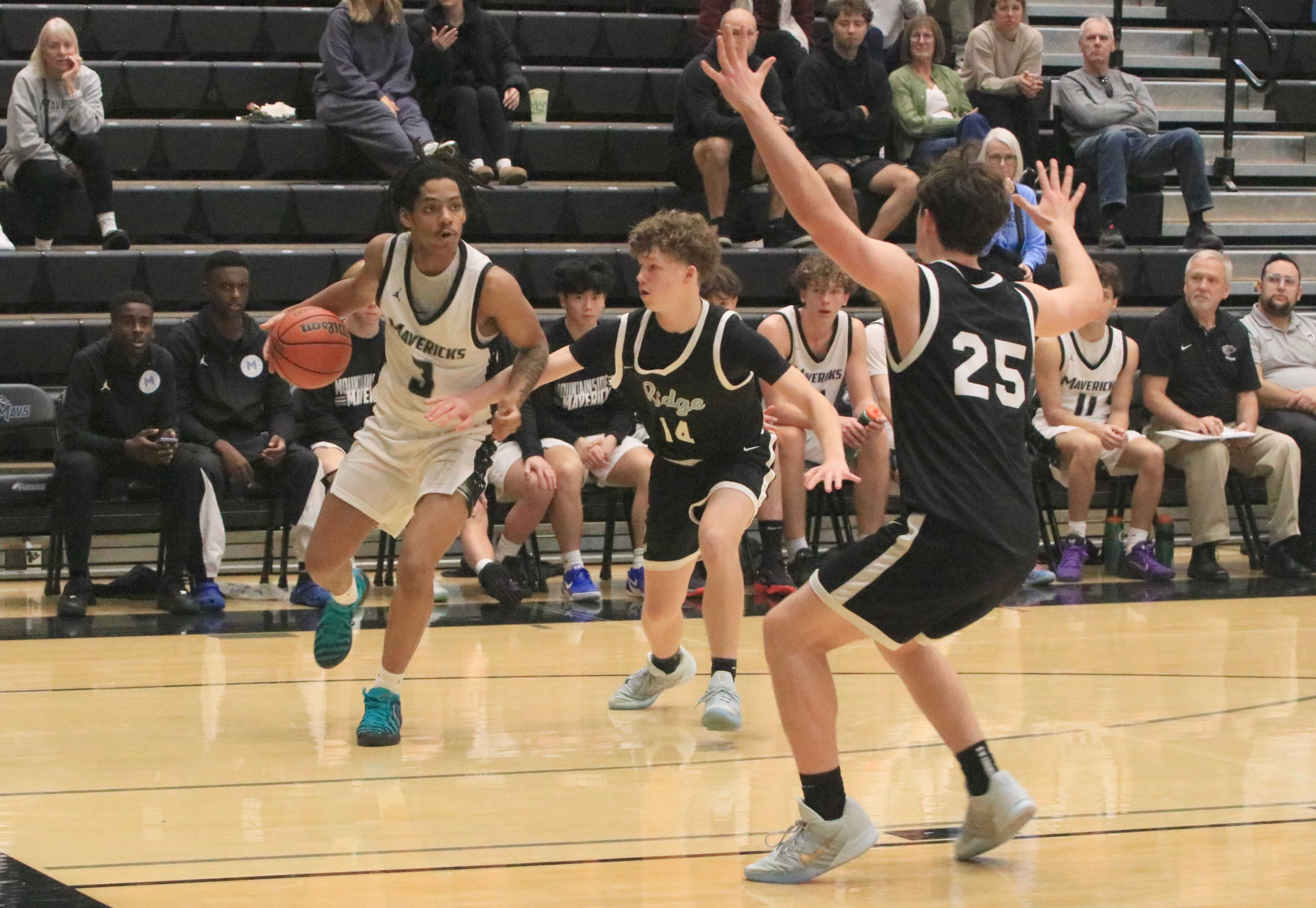 Mountainside's Kobi Nicholson (3) draws pressure from Lakeridge's Carson Pickens (14) and Daniyal Lewis (25). (Jim Beseda photo)