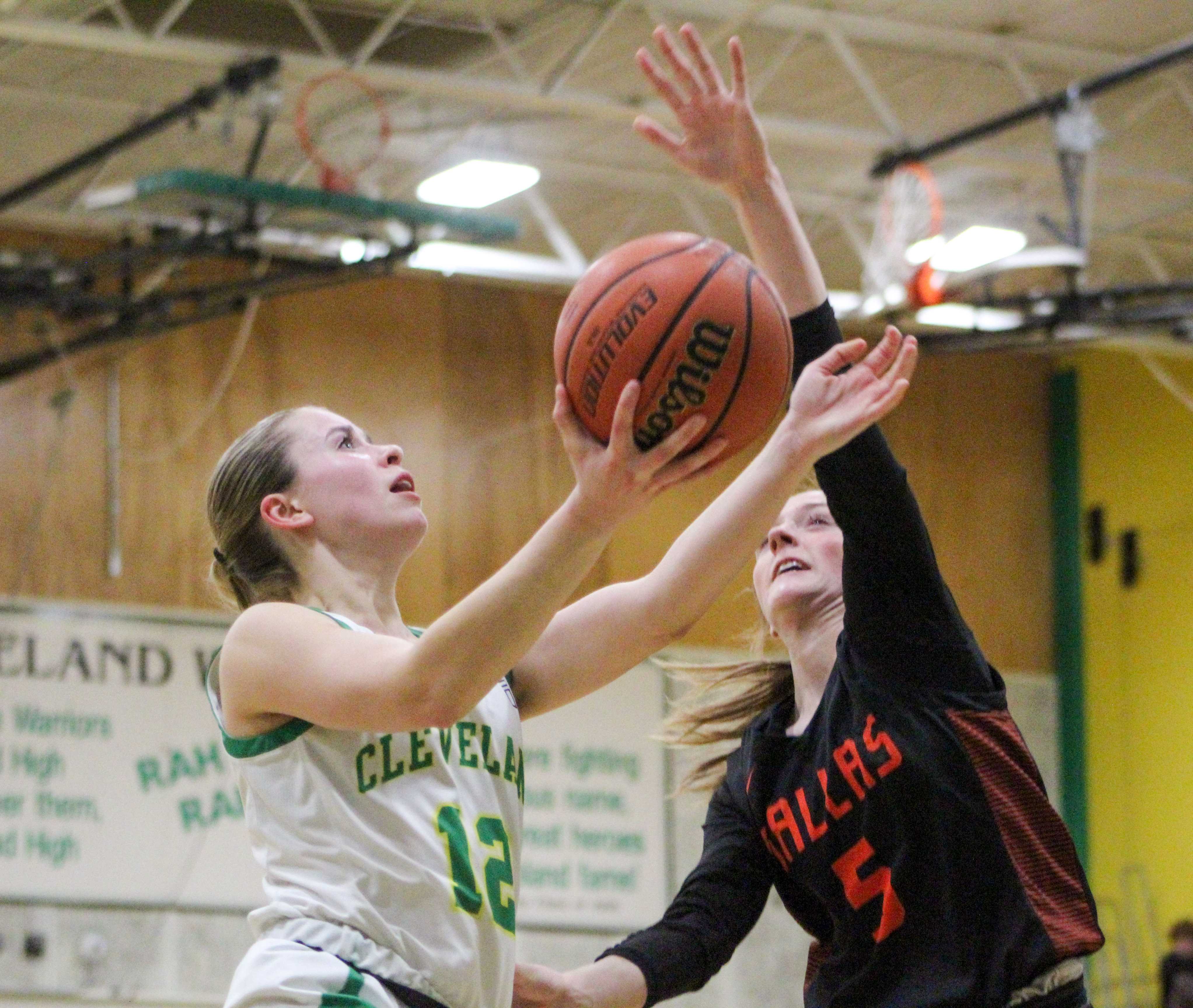 Cleveland's Charlotte Gardner, left, goes up for a layup against Dallas. (Photo by Austin White/Portland Preps)
