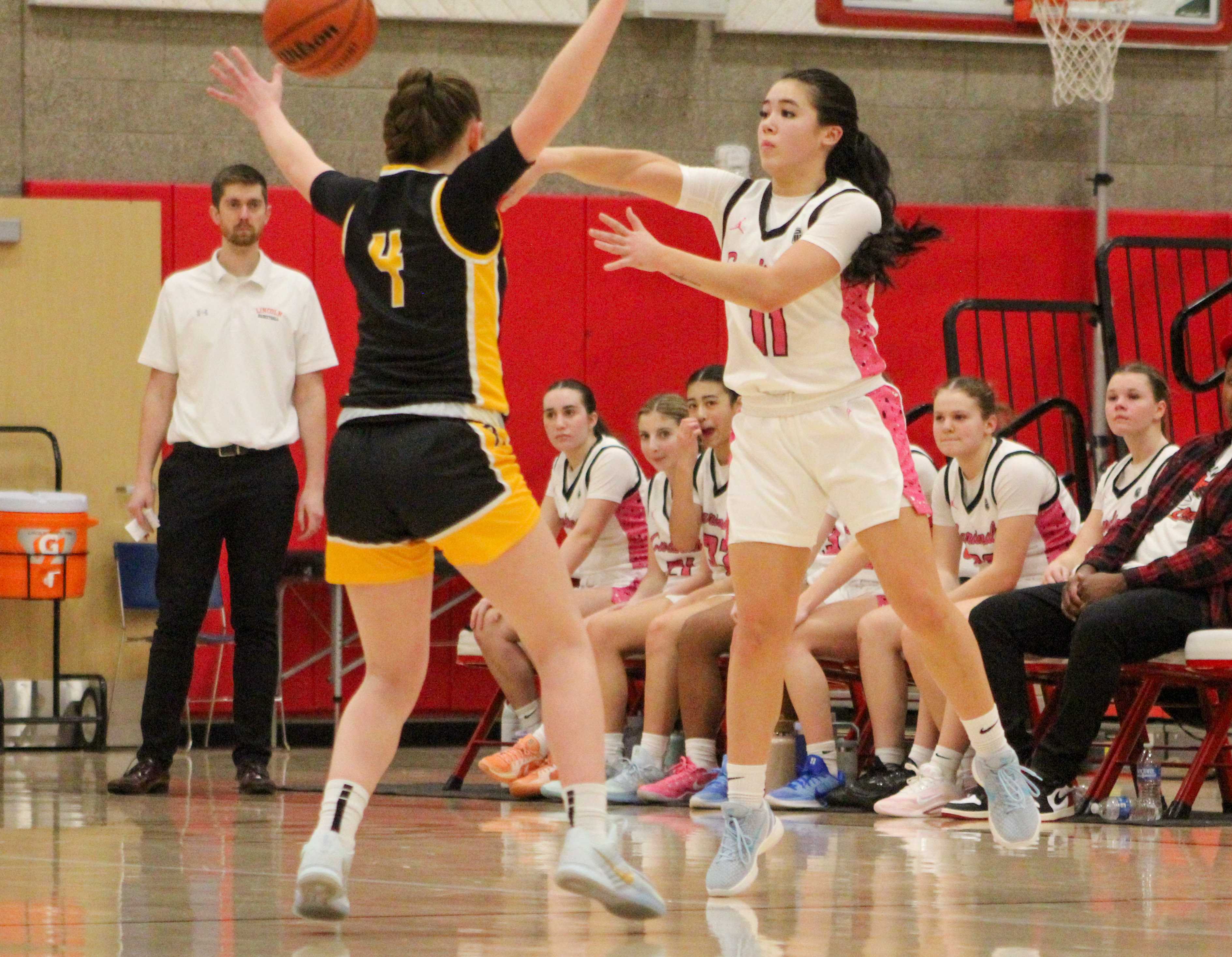 Lincoln's Siri Lindsey, right, makes a pass against Roosevelt. (Photo by Austin White/Portland Preps)
