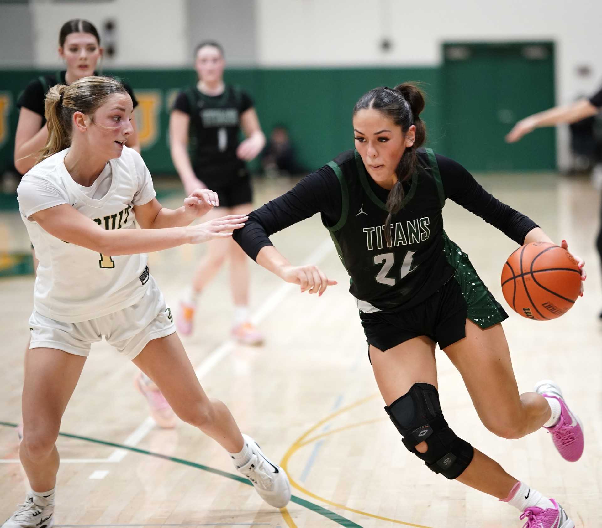 West Salem senior Emma Zuniga (24) drives against Jesuit's Reese Filkins in Saturday's playoff game. (Photo by J.R. Olson)