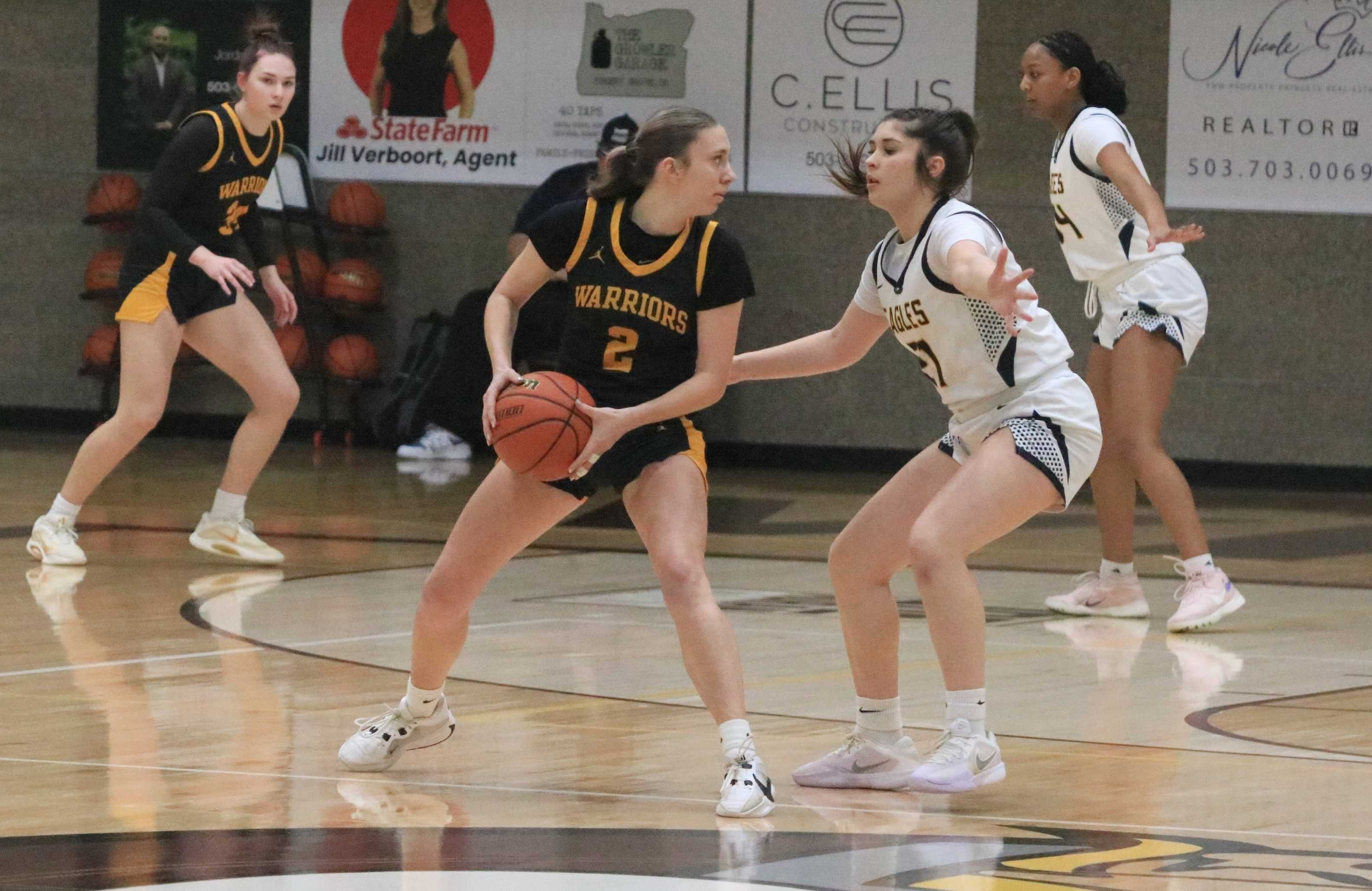 Philomath's Reagan Nuno (2) draws pressure from Stayton's Breeci Hampton during Thursday's 4A girls basketball quarterfinal.