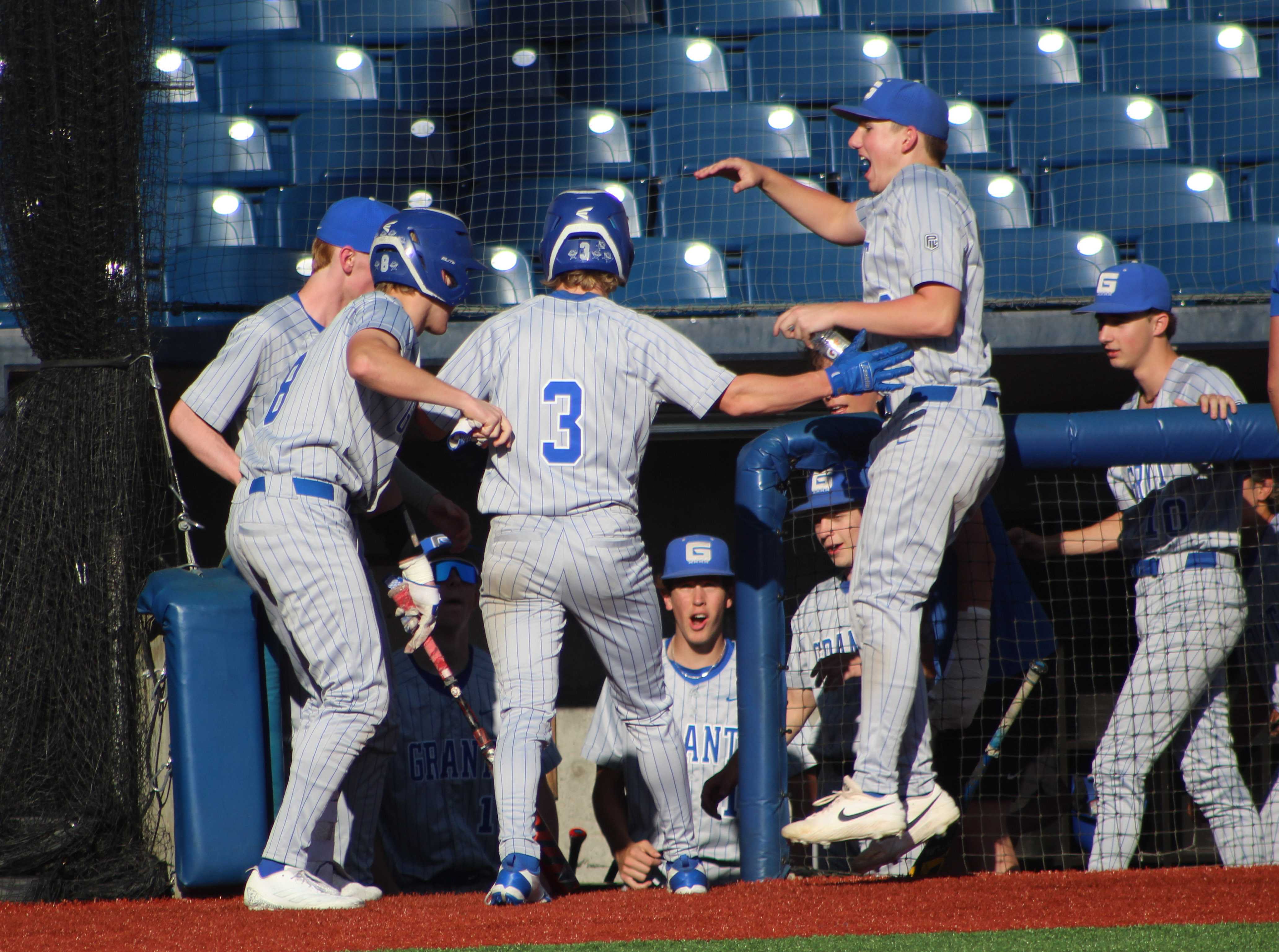Grant baseball players celebrate a run scored in a 3-2 win over Lincoln. (Photo by Austin White/Portland Preps)