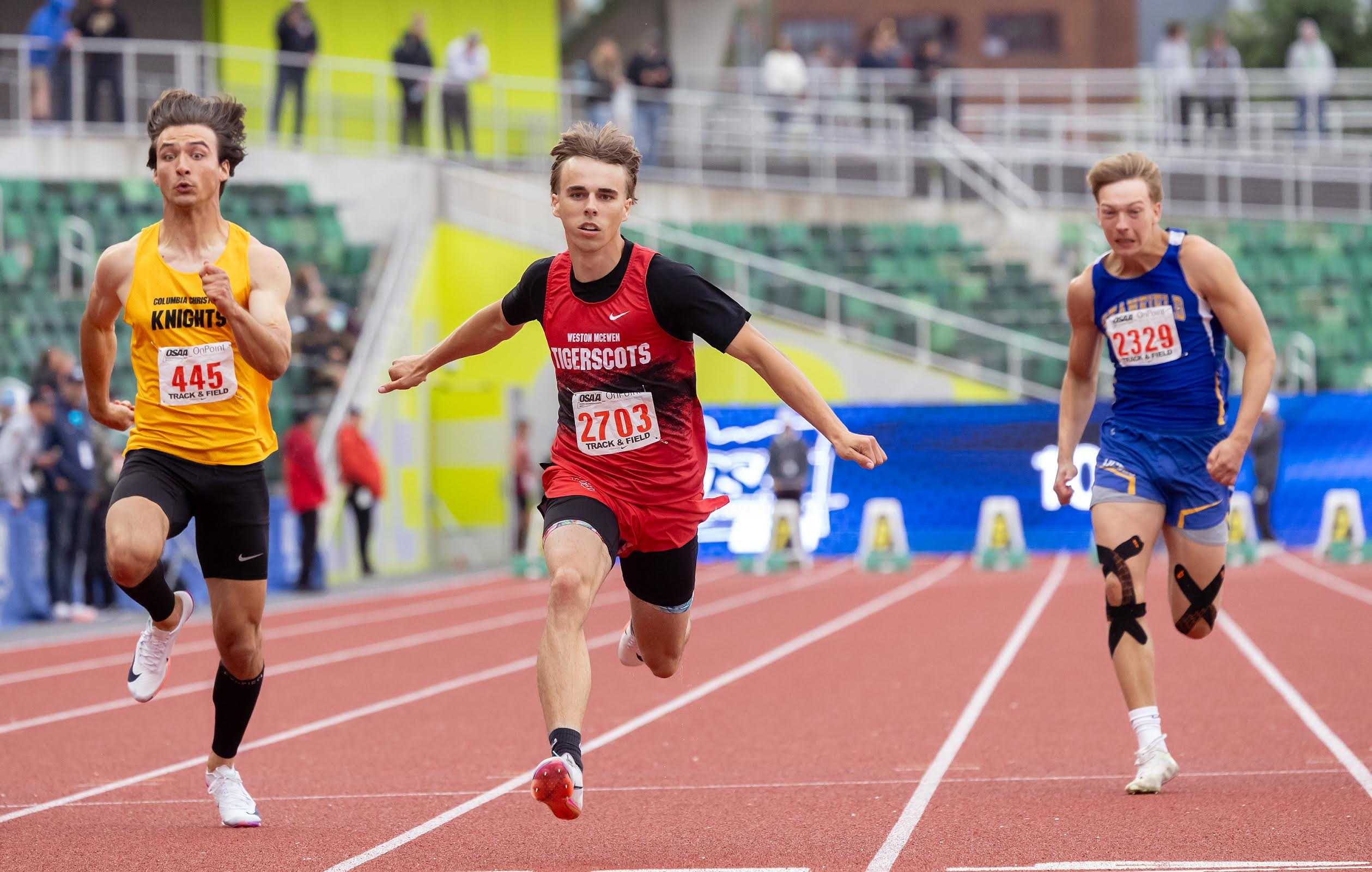 Weston-McEwen's Wyatt Parsons (center) won the 100 and 200 and anchored the winning 4x100 relay Friday. (Kathy Aney)