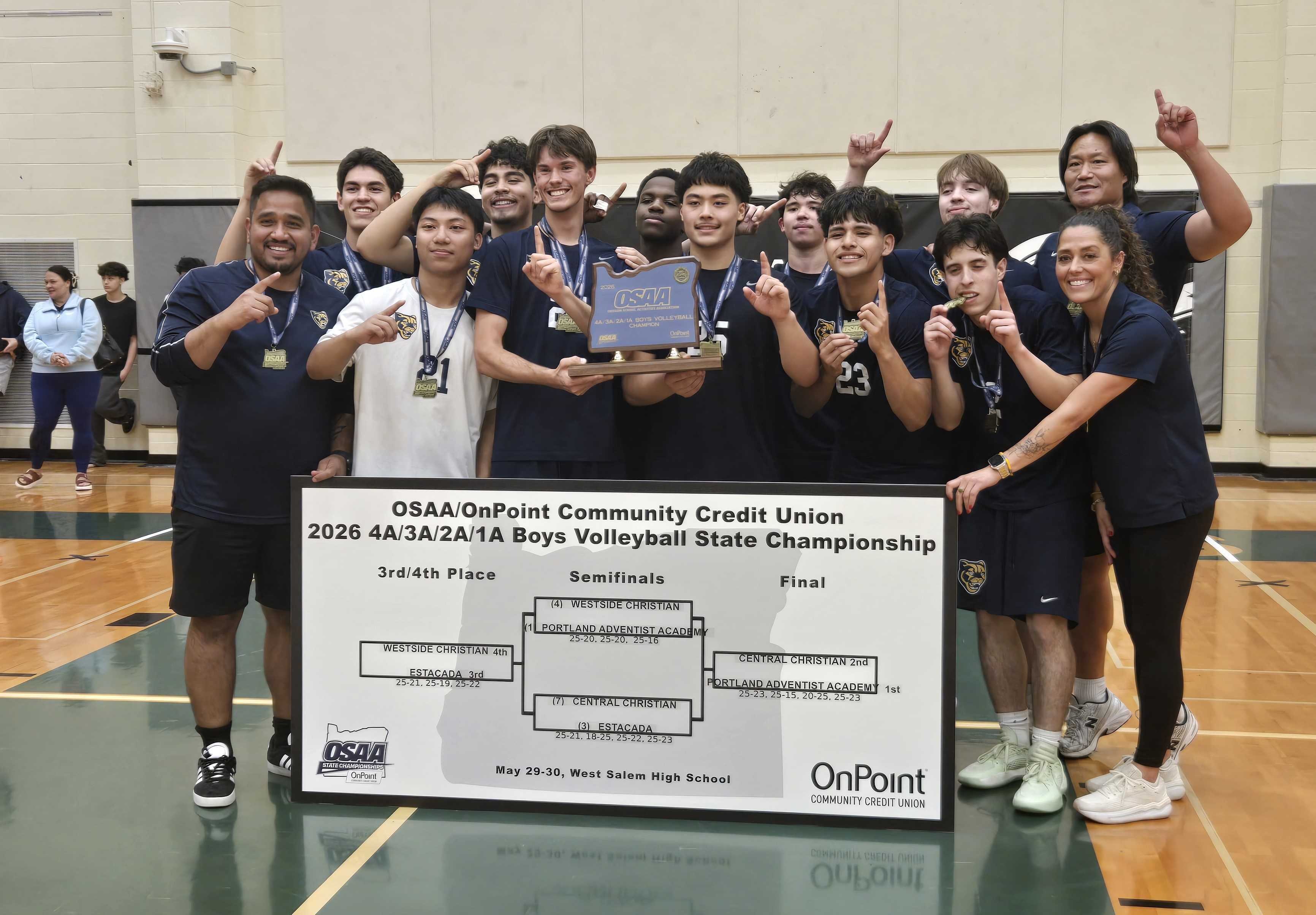 Portland Adventist boys volleyball poses with the state title trophy. (Photo by Austin White)