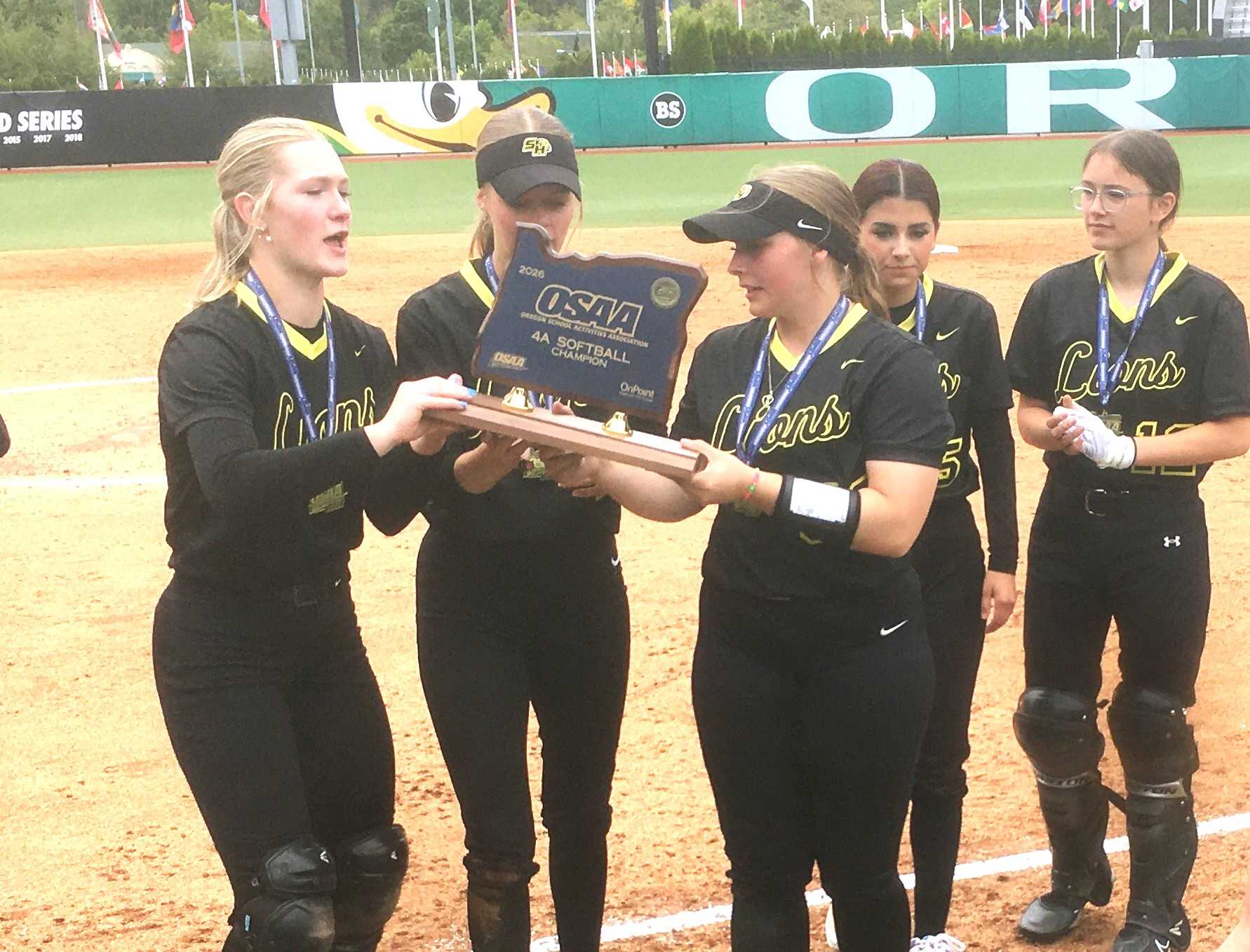 St. Helens players hoist the state championship trophy after downing Scappoose 5-3 in Saturday's 4A final.