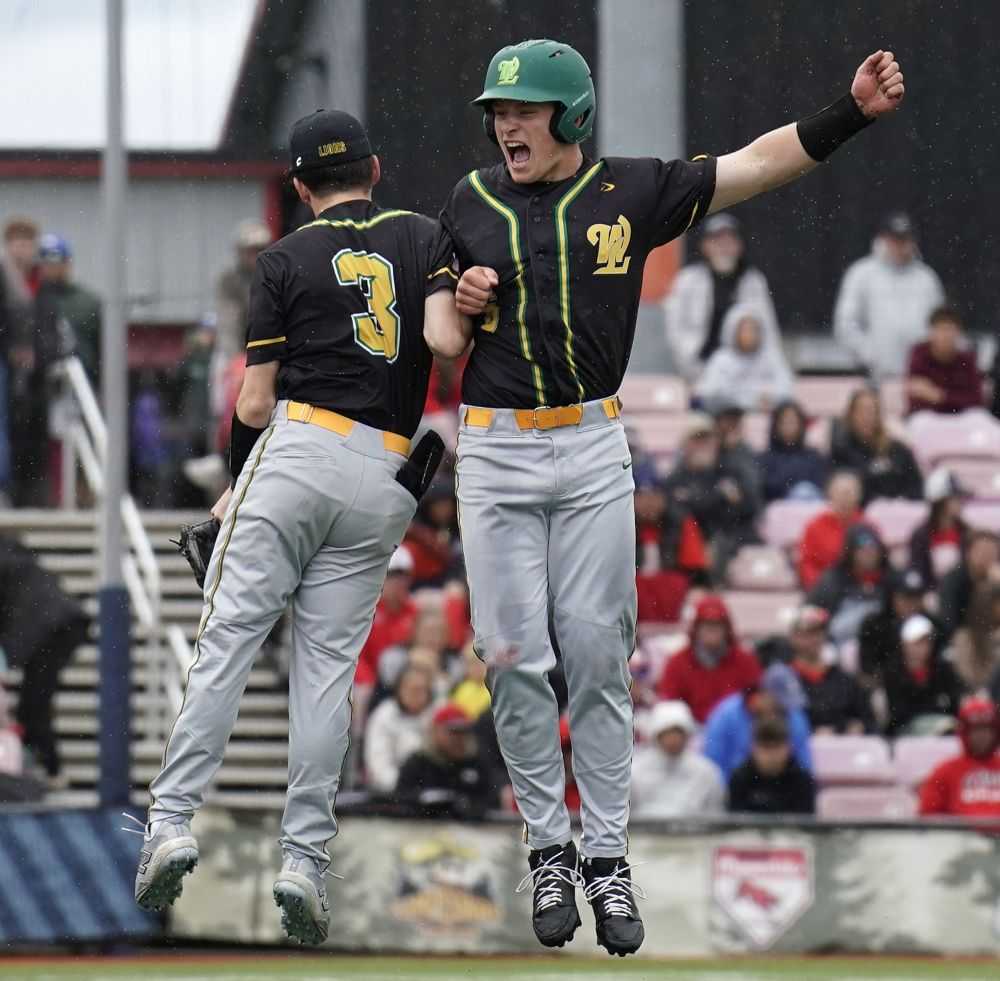 Hank Curdy (3) and Tyler Holmes celebrate a fourth state title over five years for the West Linn Lions (JR Olson)