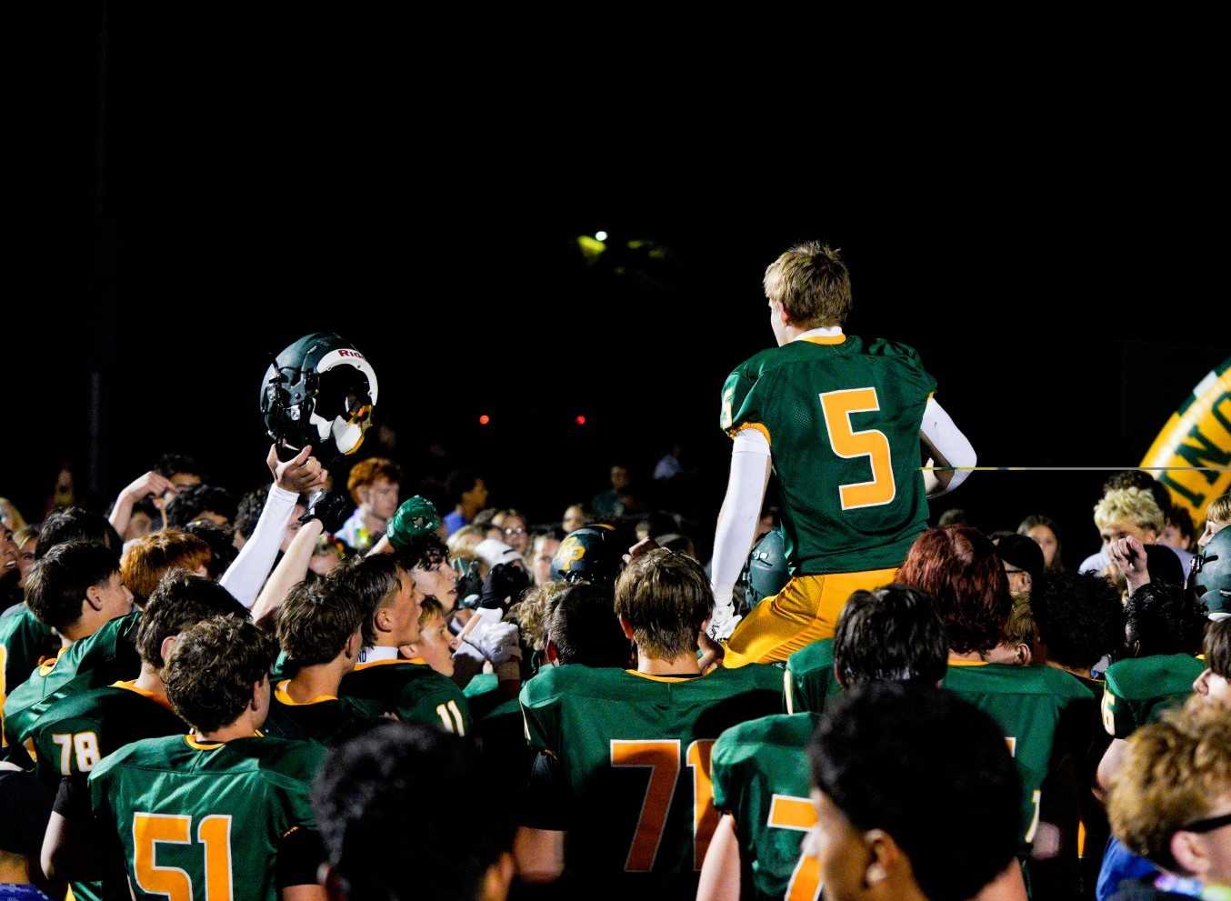 Cody Albin (5) and his Putnam teammates celebrate ending a 29-game losing streak Friday night. (Photo by Jacob Weiderhold)